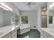 Bright bathroom features a soaking tub, double vanities, a walk-in shower and a large window at 9395 Clublands Dr, Alpharetta, GA 30022