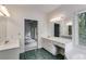 Bathroom view featuring a vanity with mirror, soaking tub, and doorway at 9395 Clublands Dr, Alpharetta, GA 30022