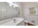Bright bathroom with large mirror, white vanity, and natural light from the window at 9395 Clublands Dr, Alpharetta, GA 30022