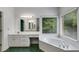 Bright bathroom features a soaking tub, double vanities, a walk-in shower and a large window at 9395 Clublands Dr, Alpharetta, GA 30022