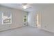 Well-lit bedroom featuring neutral carpet, bright windows and closet space at 9395 Clublands Dr, Alpharetta, GA 30022