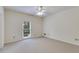 Empty bedroom featuring neutral walls, carpet, a bright window, and ceiling fan at 9395 Clublands Dr, Alpharetta, GA 30022