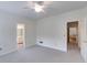 Carpeted bedroom offering ample space, natural light, and a ceiling fan at 9395 Clublands Dr, Alpharetta, GA 30022