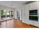 Dining area with hardwood floors, large windows, and access to the outdoor deck at 9395 Clublands Dr, Alpharetta, GA 30022