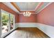 Formal dining room features hardwood floors, a large window, and decorative trim at 9395 Clublands Dr, Alpharetta, GA 30022