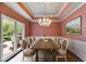 Dining room showcases large windows, decorative chandelier, and space for a large gathering at 9395 Clublands Dr, Alpharetta, GA 30022