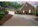 Beautiful brick home with a spacious driveway, two-car garage, and well-manicured landscaping at 9395 Clublands Dr, Alpharetta, GA 30022