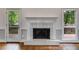 Close up of the fireplace featuring white tile surround and access to the outdoor deck at 9395 Clublands Dr, Alpharetta, GA 30022