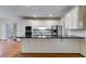 Bright kitchen with white cabinetry, granite countertops and stainless steel appliances at 9395 Clublands Dr, Alpharetta, GA 30022