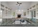 View of the kitchen features a stainless steel sink, ample counter space, and white cabinetry at 9395 Clublands Dr, Alpharetta, GA 30022