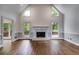 Spacious living room featuring hardwood floors, fireplace and an access to the deck at 9395 Clublands Dr, Alpharetta, GA 30022