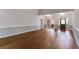 Large living room with hardwood floors and neutral paint ready for your personal touch at 9395 Clublands Dr, Alpharetta, GA 30022