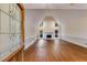 Inviting living room with hardwood floors, a vaulted ceiling, and a cozy fireplace feature at 9395 Clublands Dr, Alpharetta, GA 30022
