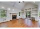 Living room boasting a brick fireplace, hardwood floors, and built-in bookshelves at 9395 Clublands Dr, Alpharetta, GA 30022