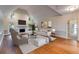 Bright living room features high ceilings, fireplace, hardwood floors, and stylish neutral decor at 9395 Clublands Dr, Alpharetta, GA 30022
