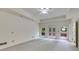The primary bedroom has a ceiling fan and offers access to a private deck with wooded views at 9395 Clublands Dr, Alpharetta, GA 30022
