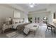 Staged primary bedroom boasts a ceiling fan, deck access and elegant decor at 9395 Clublands Dr, Alpharetta, GA 30022