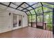 Cozy screened porch featuring wood floors, ceiling and double doors to the interior at 9395 Clublands Dr, Alpharetta, GA 30022