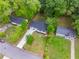 Aerial view of a home showcasing its new roof, driveway, and the surrounding landscape with mature trees at 2026 Rebecca Ln, Decatur, GA 30032