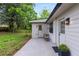 Backyard patio area with white siding, outdoor seating, and lush greenery surrounding the property at 2026 Rebecca Ln, Decatur, GA 30032