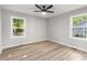 Bright bedroom featuring two windows, light gray walls, and wood-look floors at 2026 Rebecca Ln, Decatur, GA 30032