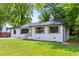 Beautiful home with lush green lawn, white-painted brick, dark window trim, and mature trees at 2026 Rebecca Ln, Decatur, GA 30032