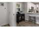 Hallway with a view into the kitchen and dining area with a stylish bar stool and glass enclosed storage unit at 2026 Rebecca Ln, Decatur, GA 30032