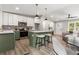 Modern kitchen with two-tone cabinetry, a large island with seating, and stainless steel appliances at 2026 Rebecca Ln, Decatur, GA 30032