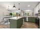 Bright kitchen featuring a large island with seating, stainless steel appliances, and an open dining area at 2026 Rebecca Ln, Decatur, GA 30032