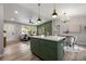Open concept kitchen island with white countertops and green cabinets provides seating and space for food preparation and entertaining at 2026 Rebecca Ln, Decatur, GA 30032