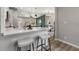 Bright, open-concept kitchen with a peninsula, seating, and stylish fixtures, offers views into other living spaces at 2026 Rebecca Ln, Decatur, GA 30032