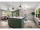 Open kitchen with a large center island, stylish pendant lighting, and views into the living space at 2026 Rebecca Ln, Decatur, GA 30032