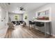 Open-concept living room featuring wood floors, modern furniture and an adjacent white brick wall with built-in shelving at 2026 Rebecca Ln, Decatur, GA 30032