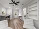 Spacious living area boasting modern decor, light wood floors, a ceiling fan, and white brick accent wall at 2026 Rebecca Ln, Decatur, GA 30032