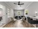 Stylish living room with white brick wall, wood floors, modern furnishings, and natural light from the surrounding windows at 2026 Rebecca Ln, Decatur, GA 30032