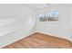 An empty bedroom is well-lit with LVP flooring and a single window view at 2211 Macon Sw Dr, Atlanta, GA 30315