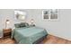 Cozy bedroom features luxury vinyl plank flooring, two windows, and matching lamps at 2211 Macon Sw Dr, Atlanta, GA 30315
