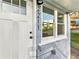 Inviting front entrance with a white door, updated exterior lighting, and fresh paint at 2211 Macon Sw Dr, Atlanta, GA 30315