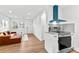 Bright living area adjacent to the modern kitchen featuring a comfortable sofa at 2211 Macon Sw Dr, Atlanta, GA 30315