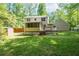 Backyard of home with luscious lawn, mature trees, screened in porch, and fenced in yard at 3078 Alberta Dr, Marietta, GA 30062