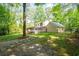 Expansive backyard features mature trees, green grass, stepping stones, and a charming two-story home at 3078 Alberta Dr, Marietta, GA 30062