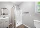 A modern bathroom includes a shower, vanity with sink, mirror, and neutral finishes for a sleek design at 3078 Alberta Dr, Marietta, GA 30062