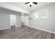 This bedroom boasts wood-look floors, neutral paint, a ceiling fan, and bright windows for a cozy feel at 3078 Alberta Dr, Marietta, GA 30062