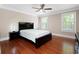 Primary bedroom boasting hardwood floors, a ceiling fan, and natural light from two windows at 3078 Alberta Dr, Marietta, GA 30062