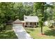 A charming one-story home with an attached garage, mature trees, and a well-kept lawn at 3078 Alberta Dr, Marietta, GA 30062