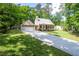 Beautiful single-story home with a two-car garage and a long driveway surrounded by trees and greenery at 3078 Alberta Dr, Marietta, GA 30062