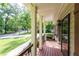 Inviting front porch featuring wood flooring and railing with views of the surrounding landscape at 3078 Alberta Dr, Marietta, GA 30062