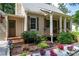 Inviting front porch with wood railing and columns, plus colorful flower beds at 3078 Alberta Dr, Marietta, GA 30062