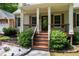 A well-maintained front porch with wood steps, railing, and manicured landscaping at 3078 Alberta Dr, Marietta, GA 30062