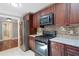 Modern kitchen featuring stainless steel appliances, granite countertops, and sleek dark wood cabinets at 3078 Alberta Dr, Marietta, GA 30062